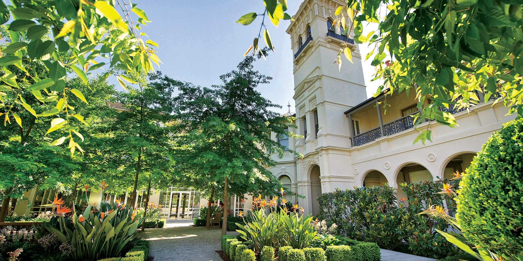 Landscaped garden surrounding a heritage building